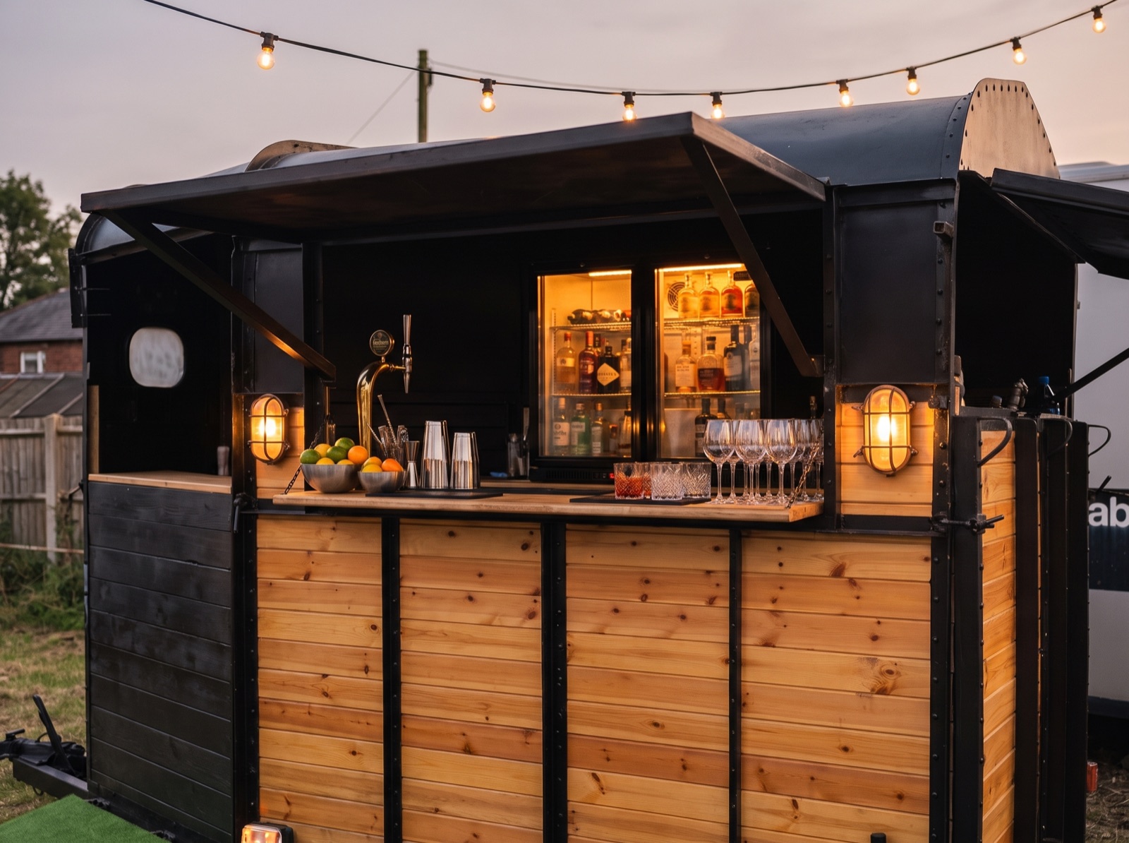 The Box set up as a bar with bottle coolers, a draught tap and glasses on the counter